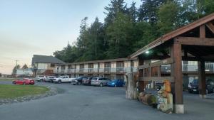 a parking lot with cars parked in front of a building at Big Rock Motel in Campbell River