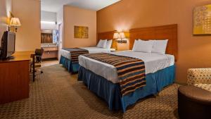 a hotel room with two beds and a television at SureStay Hotel by Best Western Ottawa in Ottawa +17 photos
