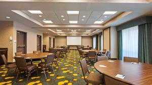 a conference room with tables and chairs and a whiteboard at Best Western Plus Dayton in Dayton