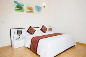 Cama o camas de una habitación en K-BOSS Hotel