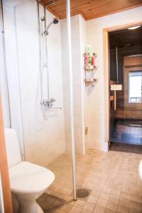 a bathroom with a shower and a toilet at Rantakari Cottage in Kotka