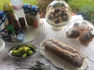 a table with a cake and a plate of food at La Bouganville in Sapri