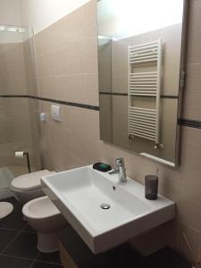 a bathroom with a sink and a toilet and a mirror at My House for Florence, Airconditioned - Easy Parking in Scandicci