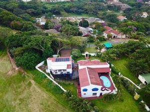 an aerial view of a large house with a swimming pool at Stroke-One-Inn in Umkomaas