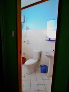 a bathroom with a toilet and a sink at Blue Corals Beach Resort in Malapascua Island
