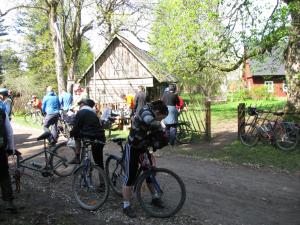 a group of people riding bikes on a dirt road at Värava Farm in Pidula