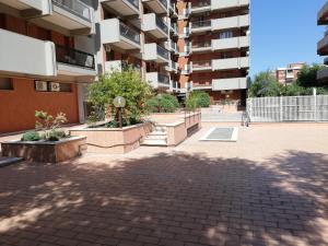 a courtyard of an apartment building with trees and plants at Maison Saint Honorè in Foggia