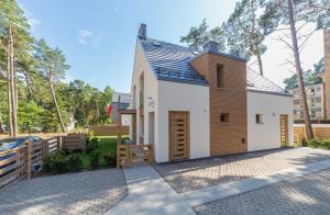 a small house with a gambrel roof at Villa Arkadia MARE in Łukęcin