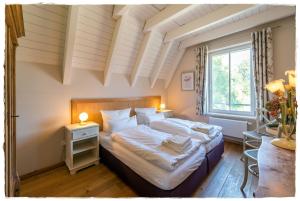 Кровать или кровати в номере Reetdachhaus Kranich mit Schwimmteich in Krienke