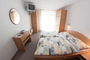 a bedroom with a bed and a mirror at Family Apartments Spiežovec in Donovaly