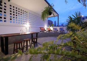a rooftop patio with a table and chairs on a building at Apartment45 Hostel in Bangkok