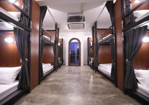 a group of bunk beds in a room with a hallway at Apartment45 Hostel in Bangkok