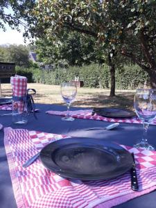 a table with a plate and wine glasses on it at La Fleur et Le Soleil (F&S) in Durbuy