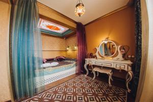 a bathroom with a vanity and a mirror and a sink at Victoria Hotel in Ulan-Ude