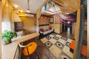 a kitchen and living room with a couch and a table at Victoria Hotel in Ulan-Ude