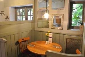
a dining room table with a lamp on it at The Horse & Jockey Inn in Knighton
