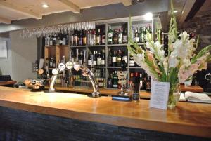 a bar with a bunch of bottles of wine at The Horse & Jockey Inn in Knighton