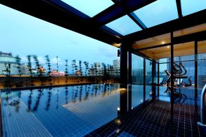 a swimming pool on the roof of a building at KUN Hotel in Taichung
