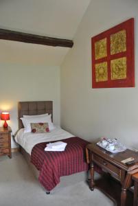 
a bedroom with a bed and a lamp at The Horse & Jockey Inn in Knighton
