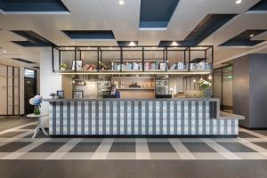 a restaurant with a blue and white checkered counter at Campanile Shanghai Jing An in Shanghai
