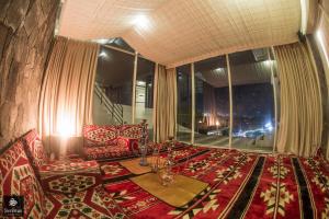 a living room with a couch and a large window at Serenus Boutique Villa in Nuwara Eliya