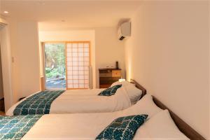 Postel nebo postele na pokoji v ubytování Auberge AZABU