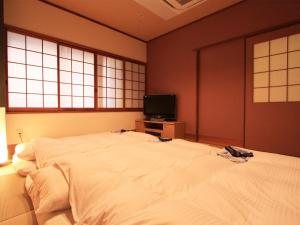 Postel nebo postele na pokoji v ubytování Hotel AreaOne Takamatsu