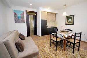 a living room with a couch and a dining room table at Apartments Mirko in Ulcinj