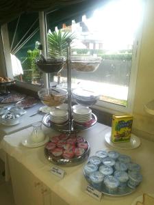 a counter with plates and other food on it at Hotel Michela in Marina di Massa