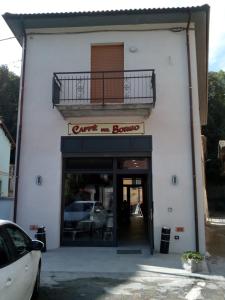 a white building with a balcony over the door at Affittacamere Il Borgo in Ceva