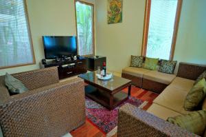 a living room with couches and a coffee table at Villa Travis in Seminyak