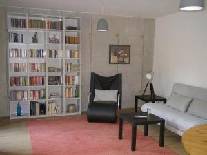 a living room with a couch and a book shelf at Studio3 in Eisenach