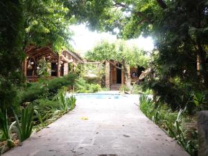 a walkway leading to a house with a pool at Machanents Guest House in Vagharshapat