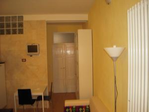 a living room with a table and a lamp at Studio Palestro in Bologna