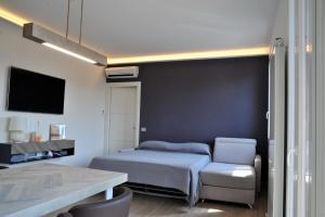 a small bedroom with a bed and a chair at Green Garda Desenzano in Desenzano del Garda