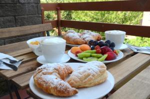 a table topped with plates of pastries and fruit at Mandala Bed & Breakfast in Viterbo