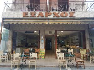 un restaurant avec des tables et des chaises en face d'un bâtiment dans l'établissement Exarchos Guest House, à Ioannina