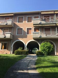 a large building with a walkway in front of it at Green Garda Desenzano in Desenzano del Garda
