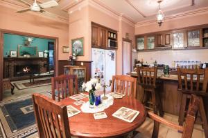 a kitchen with a wooden table and chairs at Rustic Refuge Guesthouse in Kalorama