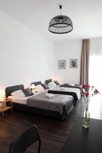 a bedroom with a large bed and a table at Apartment City Lenaustrasse | contactless check-in in Hannover