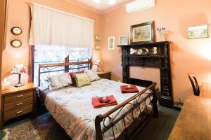 a bedroom with a bed and a table and a window at Rustic Refuge Guesthouse in Kalorama