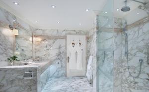 a bathroom with a tub and a shower at The Ritz London in London