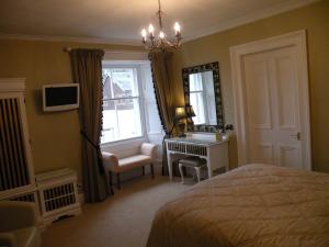 
a bedroom with a large bed and a large window at Thistle House Guest House in Saint Catherines
