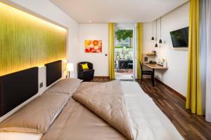 TV a/nebo společenská místnost v ubytování Hotel Jardin Bern