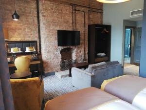 a living room with a brick wall and a fireplace at The Old Borough Hotel - Wetherspoon in Swords