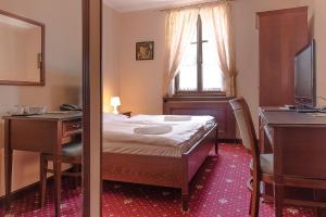 Postel nebo postele na pokoji v ubytování Hotel Buchlovice