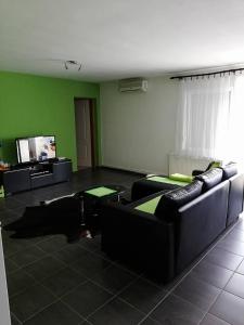 a living room with couches and a flat screen tv at Apartment at Gagijevo sedlo in Morović