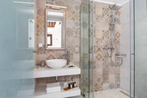 a bathroom with a sink and a shower at Lindos Vista Luxury Villa in Lindos