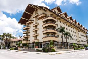 an apartment building with balconies on a street at Dall’Onder Grande Hotel Bento Gonçalves in Bento Gonçalves