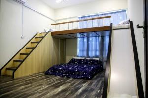 a bedroom with a bunk bed and a staircase at Sibu Swanhouse No.3 in Sibu